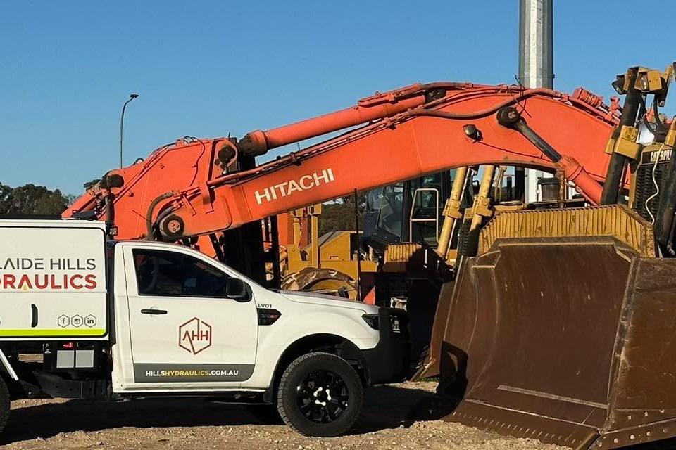 Adelaide Hills Hydraulics mobile service vehicle repairing hydraulic hoses on a Hitachi excavator near Mount Barker
